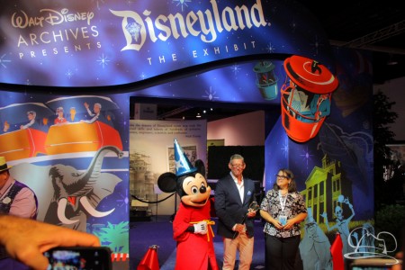Walt Disney Company VP for Corporate Communications Adam Sanderson is joined by Becky Cline, and Sorcerer Mickey Mouse - Ribbon cutting ceremony of Disneyland The Exhibit at the D23 Expo 