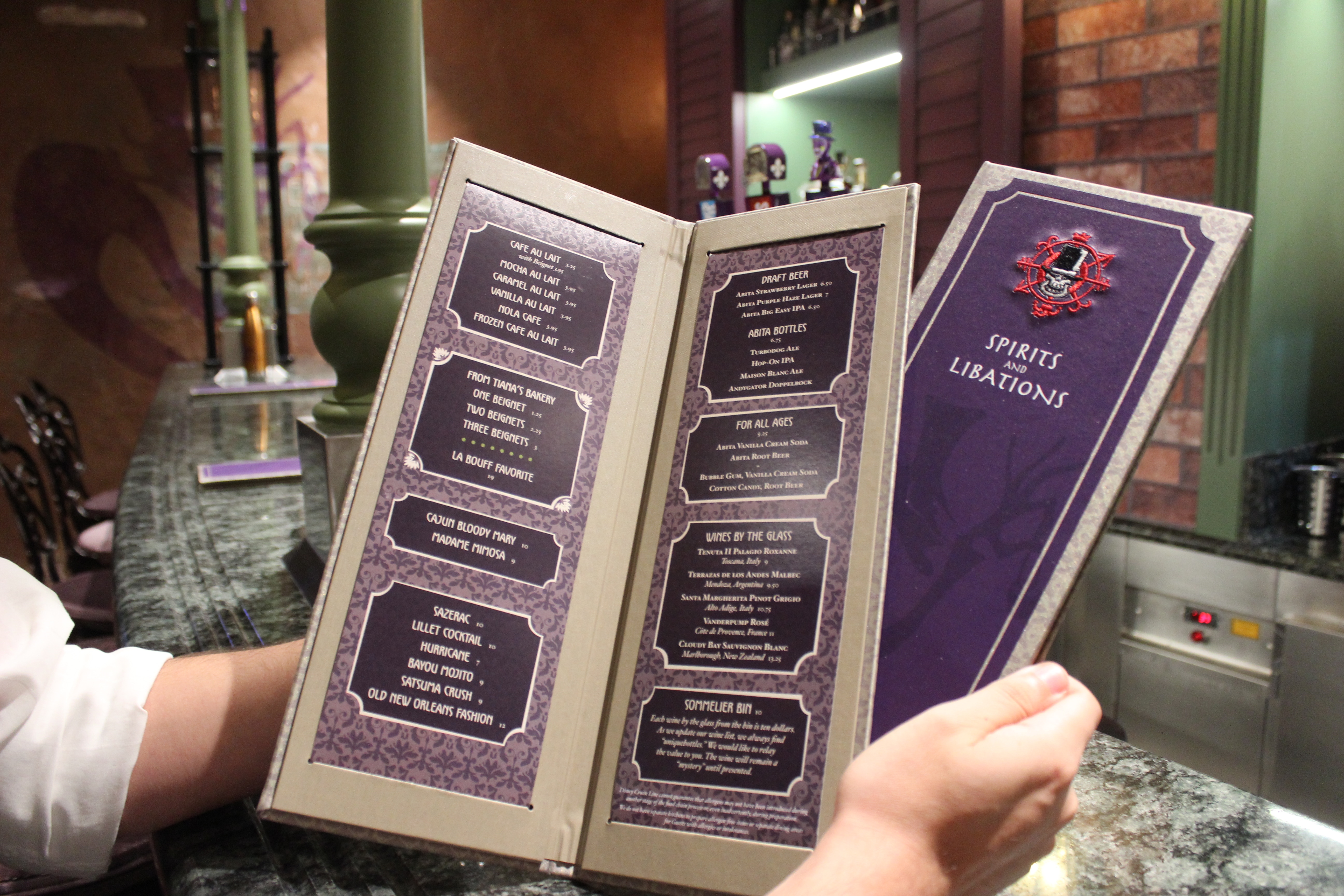 The menu covers a variety of drinks and sweet treats. The cover sports an image of the Shadow Man that appears and disappears depending on the light.